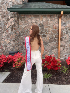 Jovani Interview Jumpsuit with Assymetric & Beaded Waistline. Slit In Pants